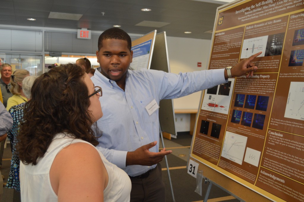 Student demonstrating his work at the Undergraduate Research Forum